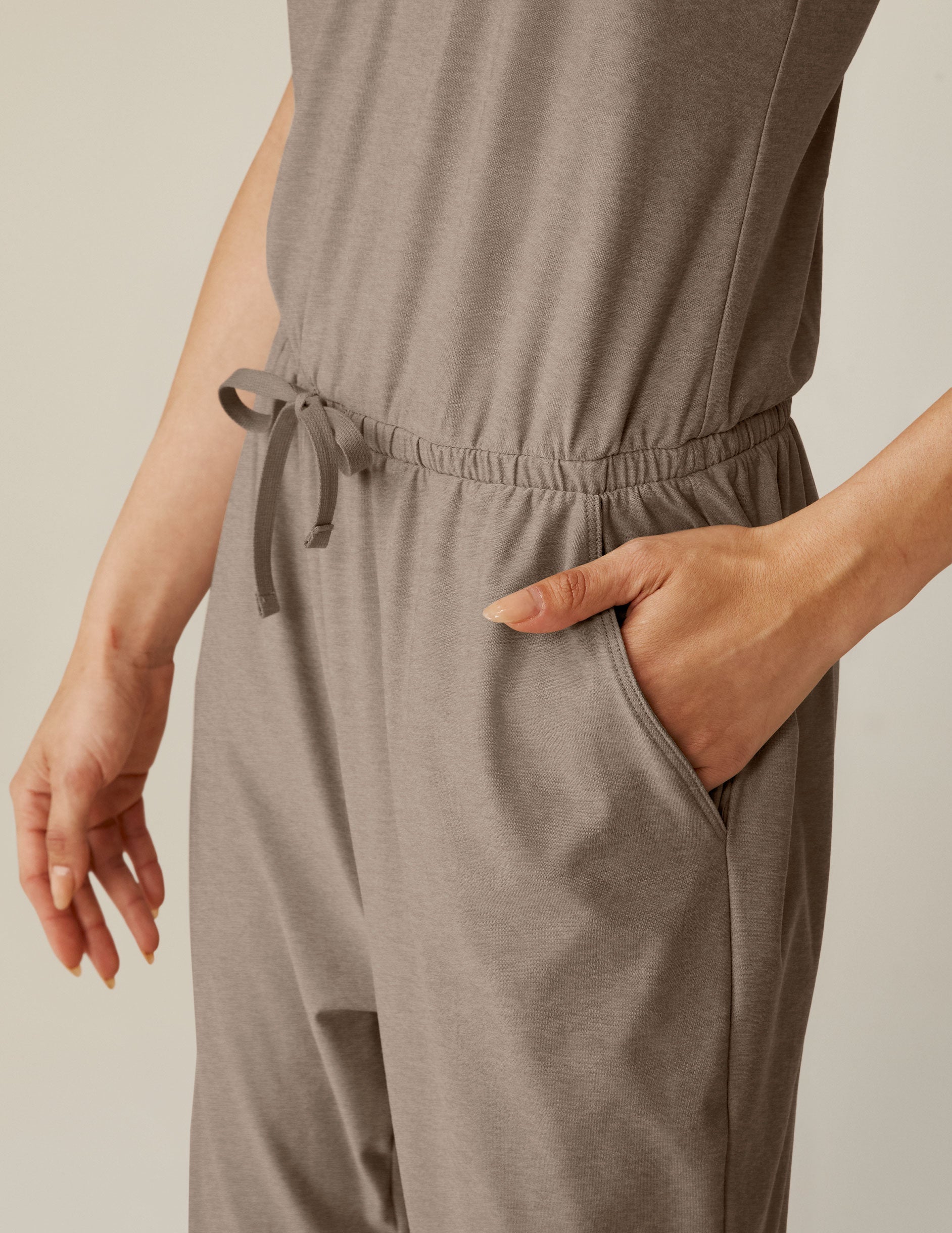 brown midi jumpsuit with a drawstring at waistband and lace trim detailing.