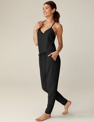 black midi jumpsuit with drawstring at waist and a lace trim at neckline.