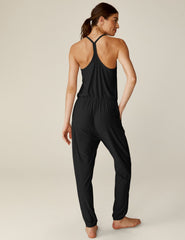black midi jumpsuit with drawstring at waist and a lace trim at neckline.