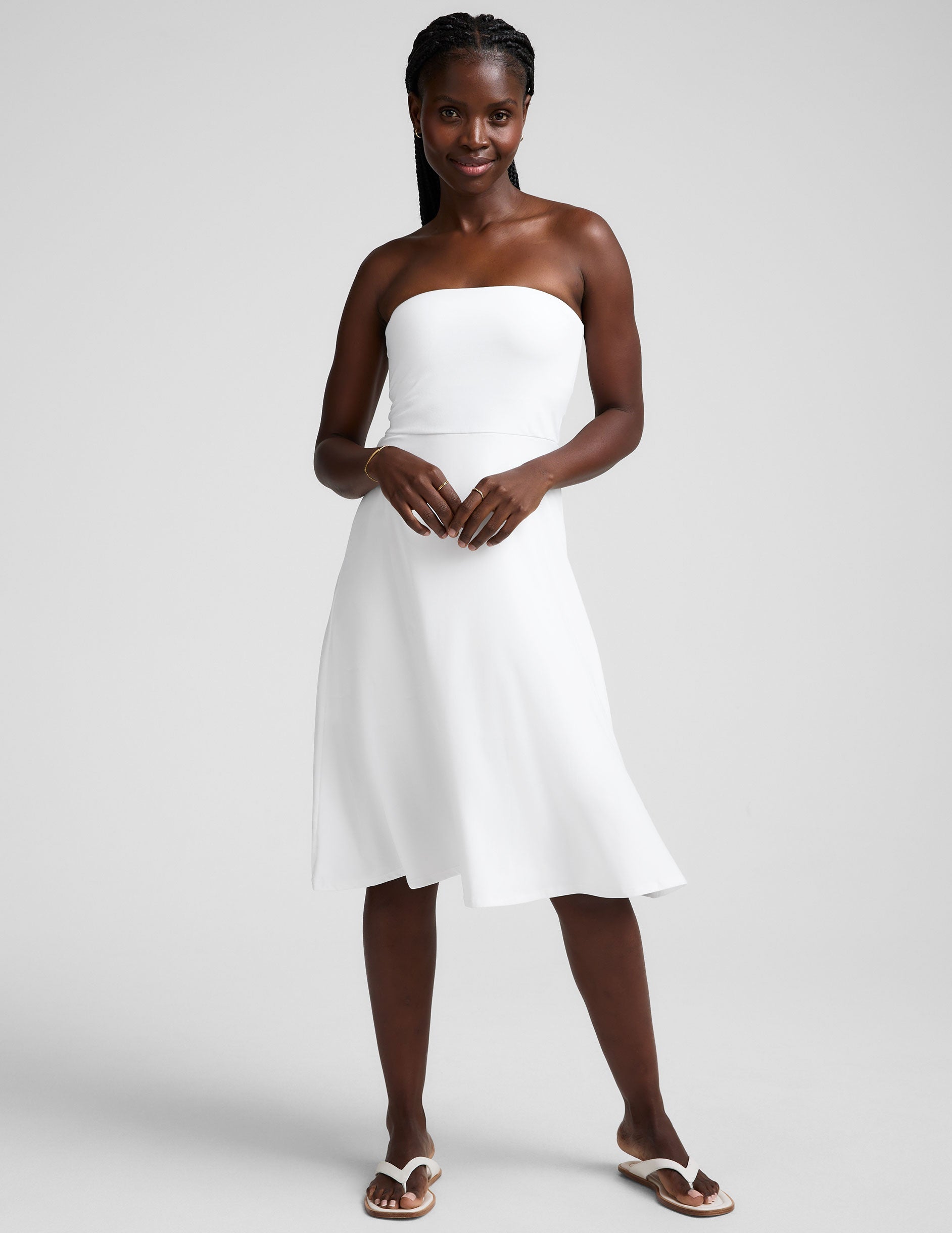 white midi length strapless dress with pockets.