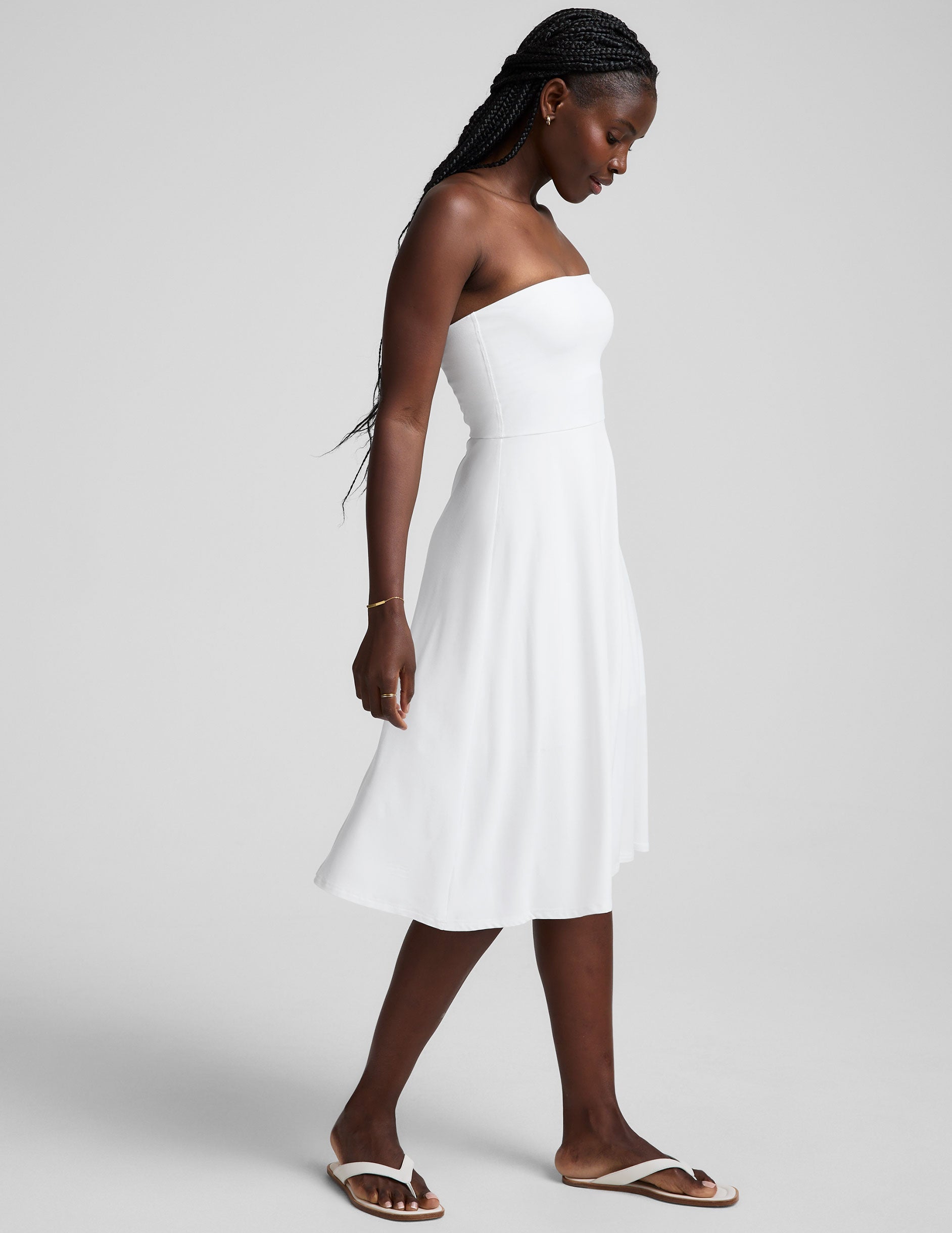 white midi length strapless dress with pockets.
