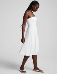 white midi length strapless dress with pockets.
