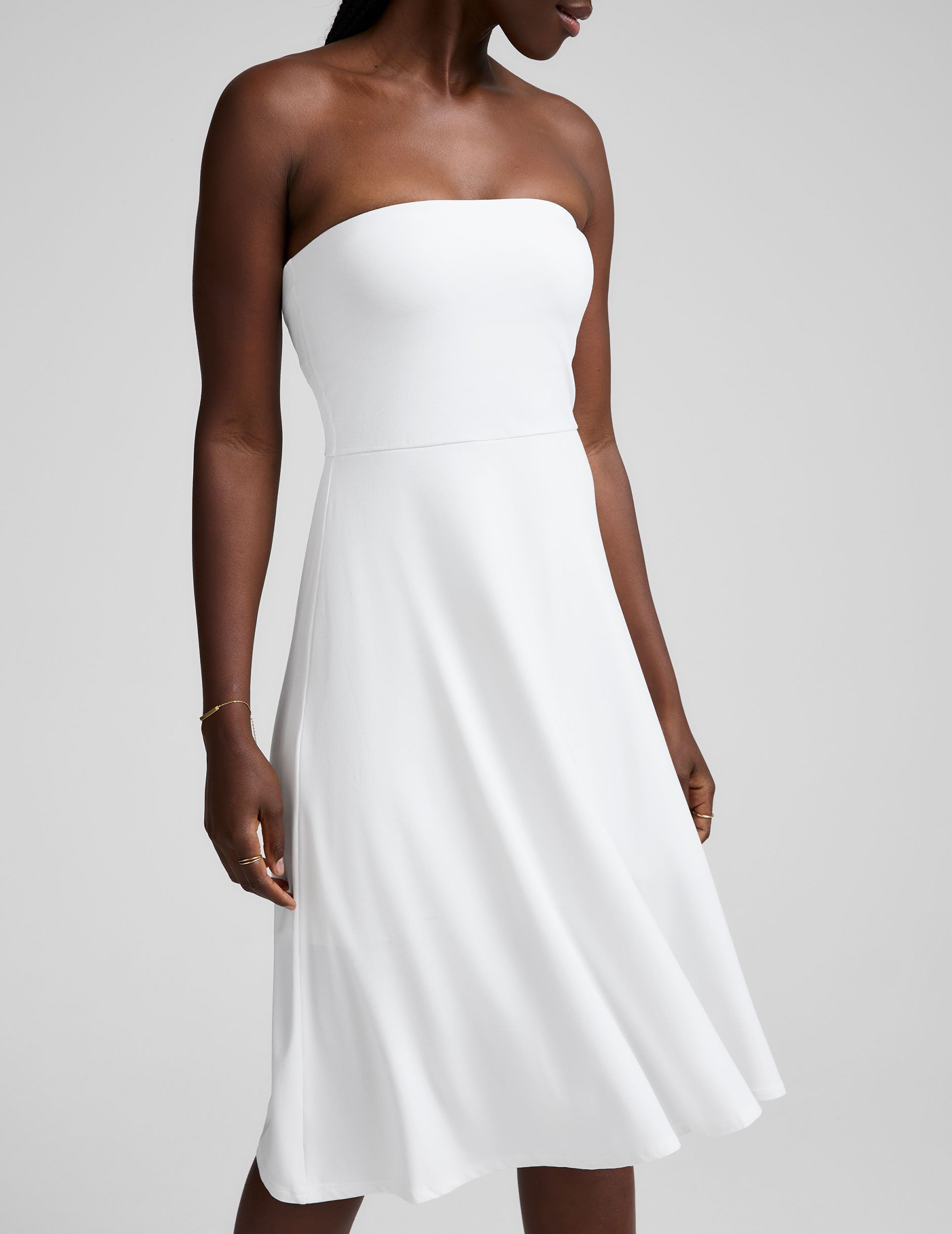 white midi length strapless dress with pockets.