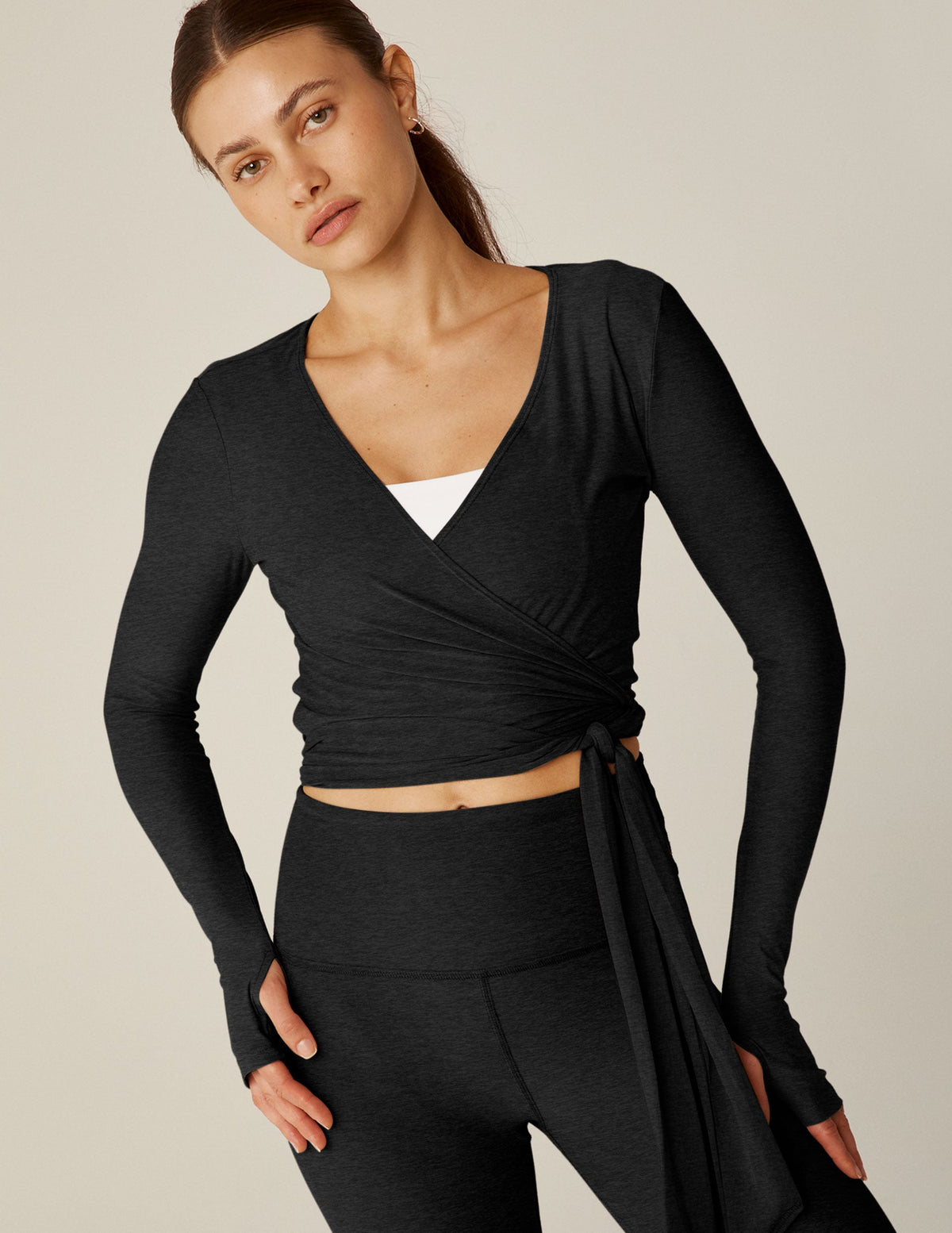 black v-neck tie wrap top with thumbholes.
