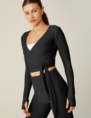 black v-neck tie wrap top with thumbholes.