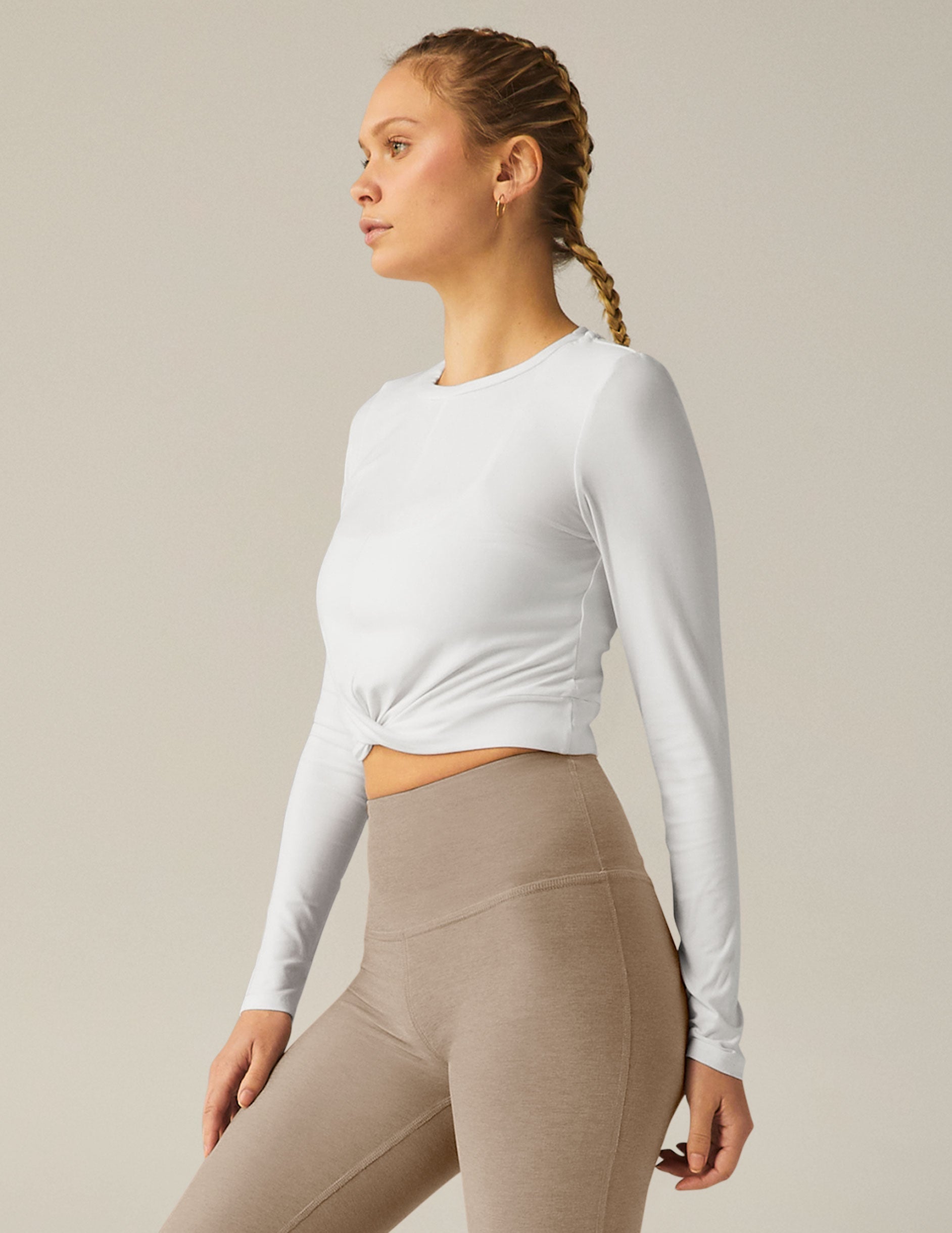 white scoop neck featherweight long sleeve cropped top with a front crossover detail.