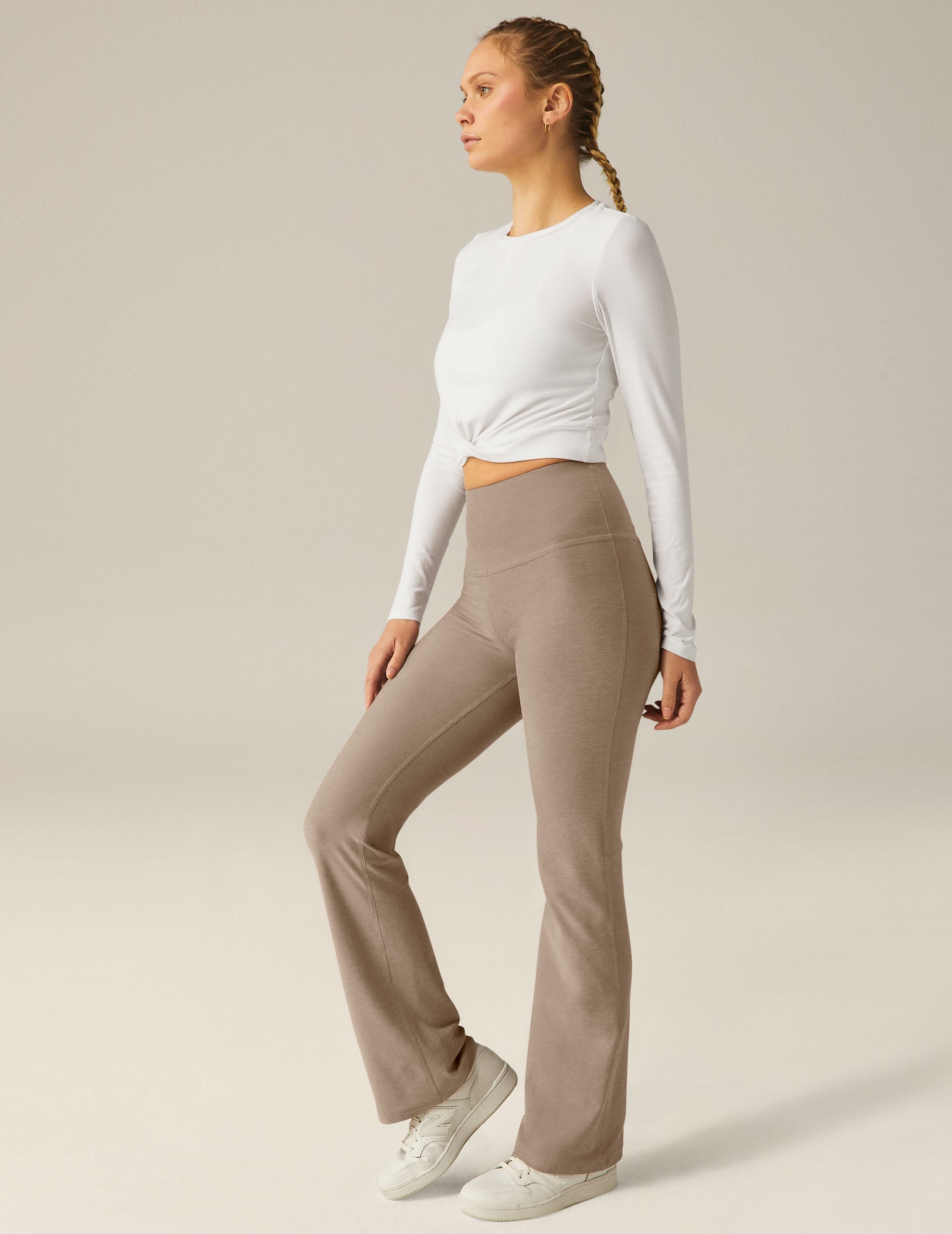 white scoop neck featherweight long sleeve cropped top with a front crossover detail.