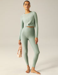 featherweight cropped fitted long sleeve top with a front crossover detail.