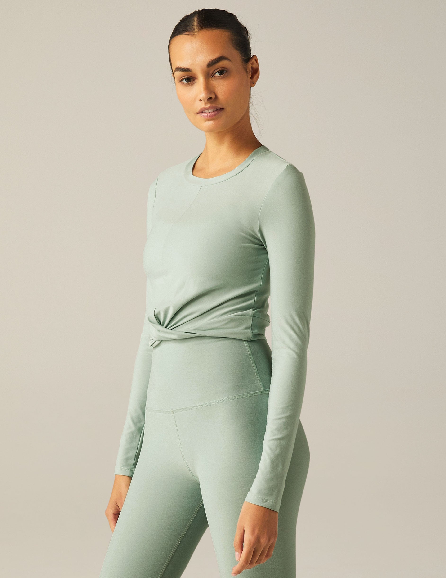 featherweight cropped fitted long sleeve top with a front crossover detail.