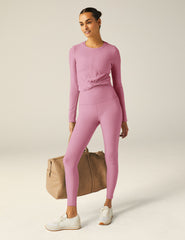 pink long sleeve top with a front twist detail.
