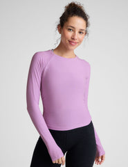 purple scoop neck long sleeve top with shirring on the sides.