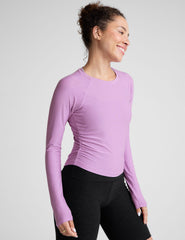 purple scoop neck long sleeve top with shirring on the sides.