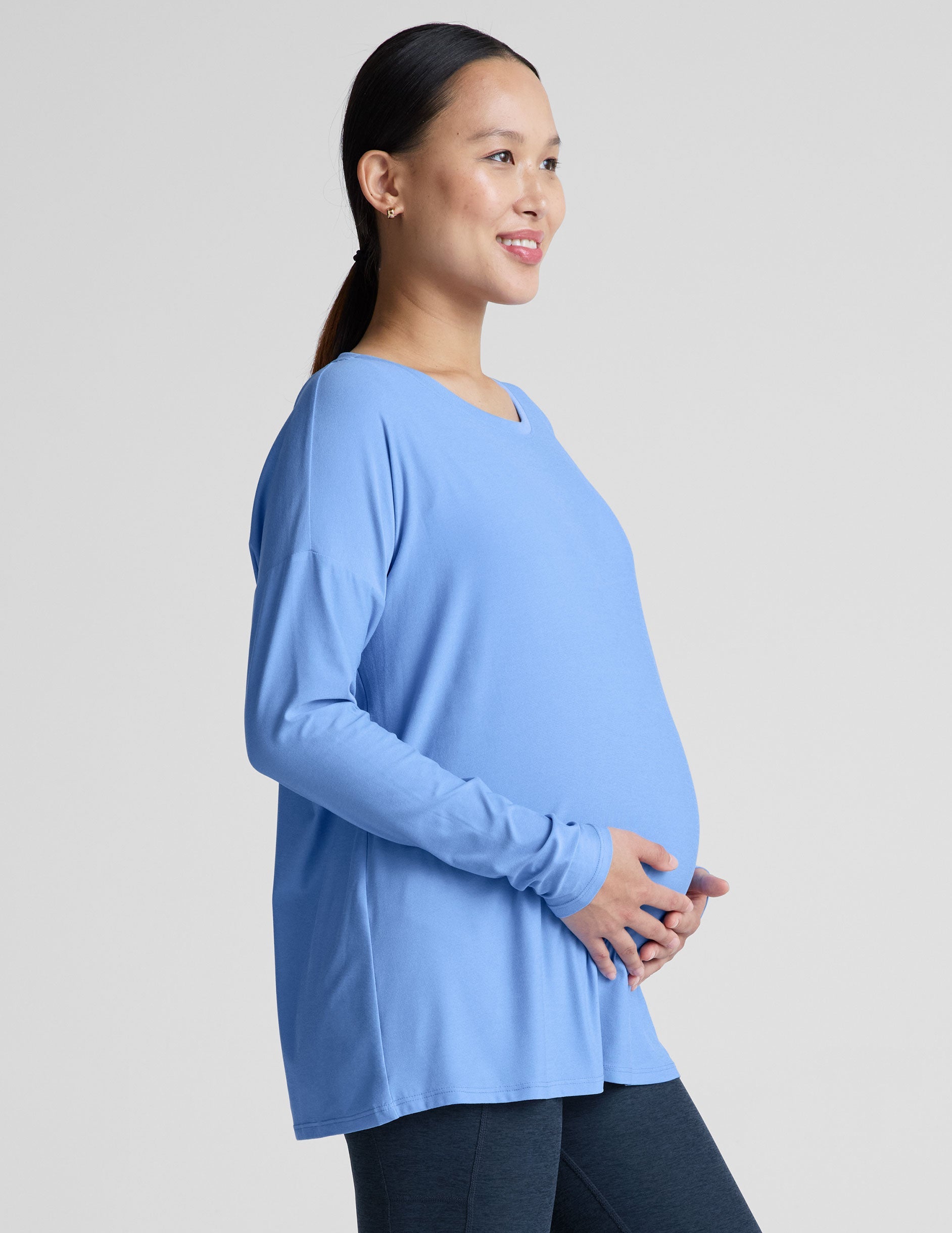 blue long sleeve maternity top with a crew neckline.