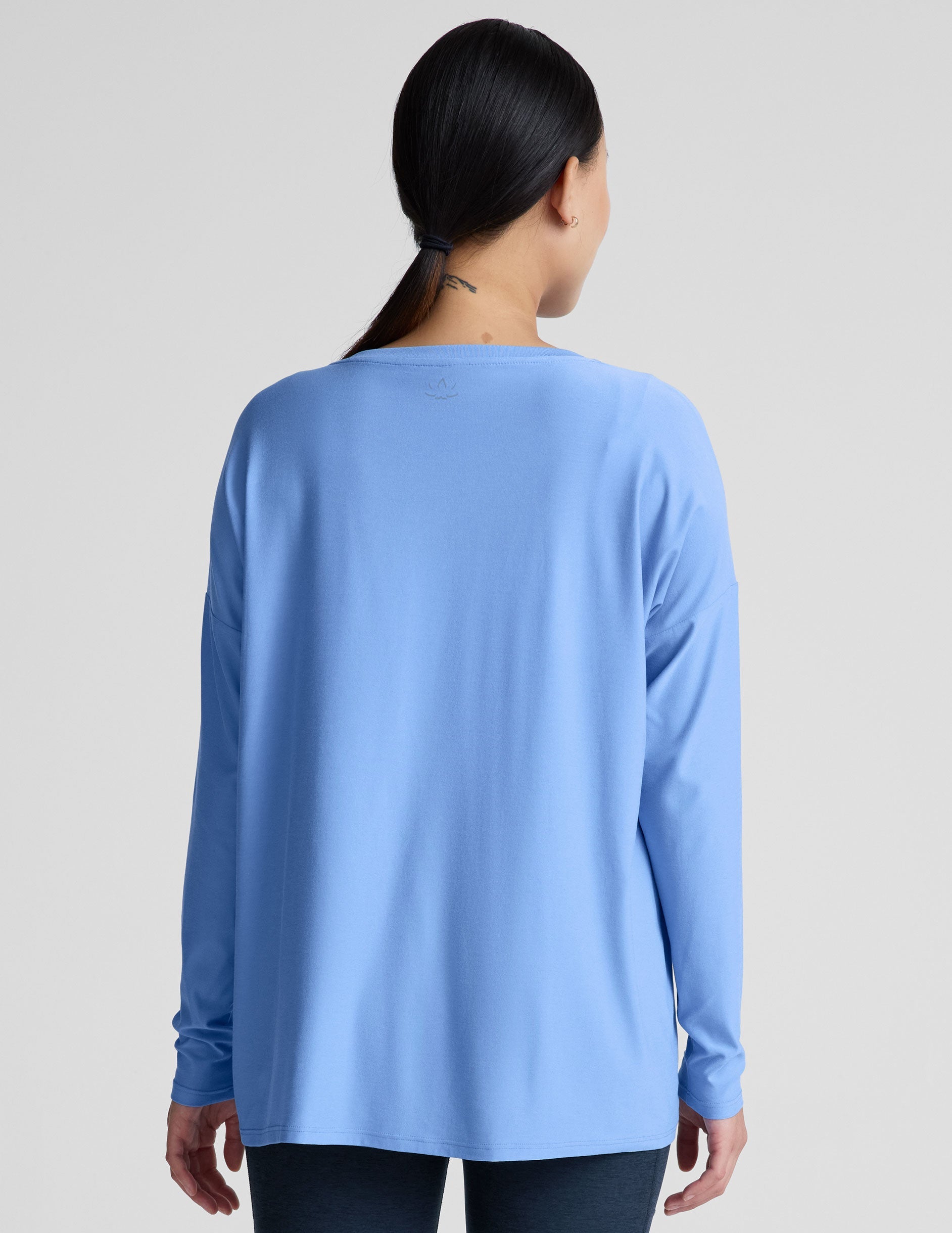 blue long sleeve maternity top with a crew neckline.