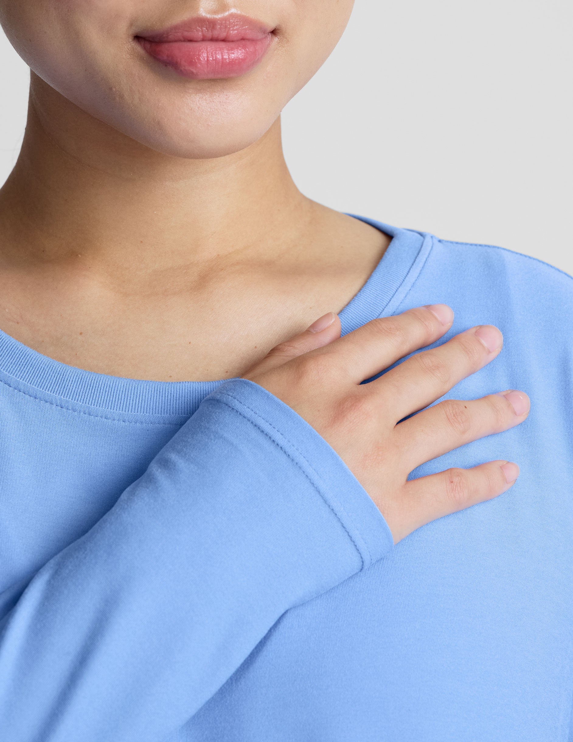 blue long sleeve maternity top with a crew neckline.