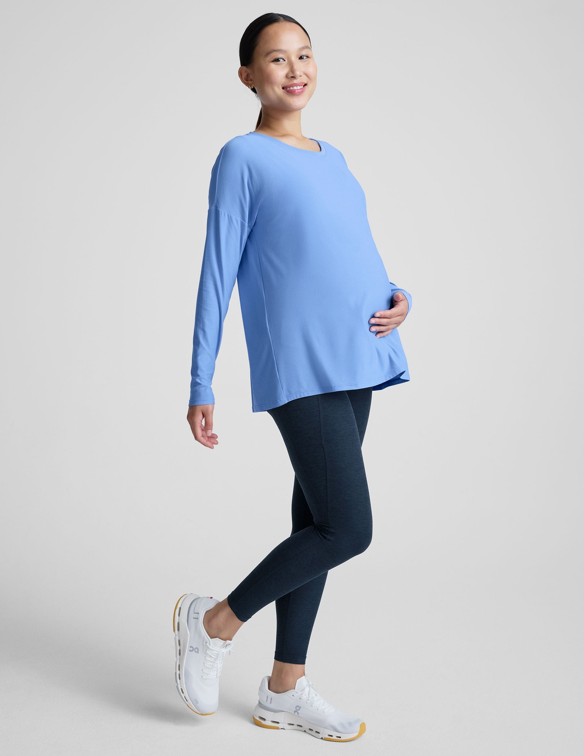 blue long sleeve maternity top with a crew neckline.