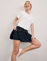 white lightweight loose-fitting cropped tee with a scoop neckline.