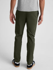 model wearing green men's chino pants on a plain background.