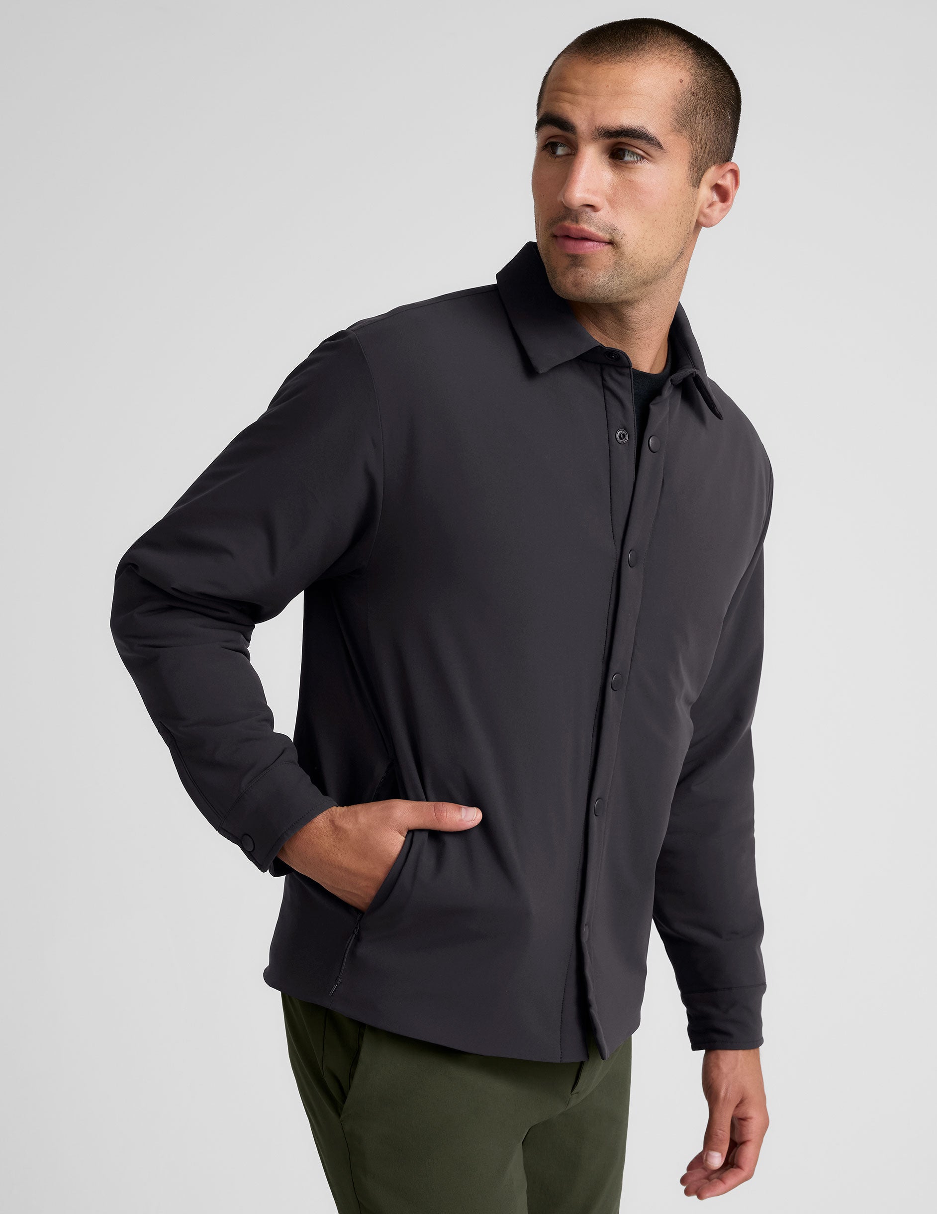 black men's button up insulated jacket with a shirt collar and side seam invisible zipper pockets.