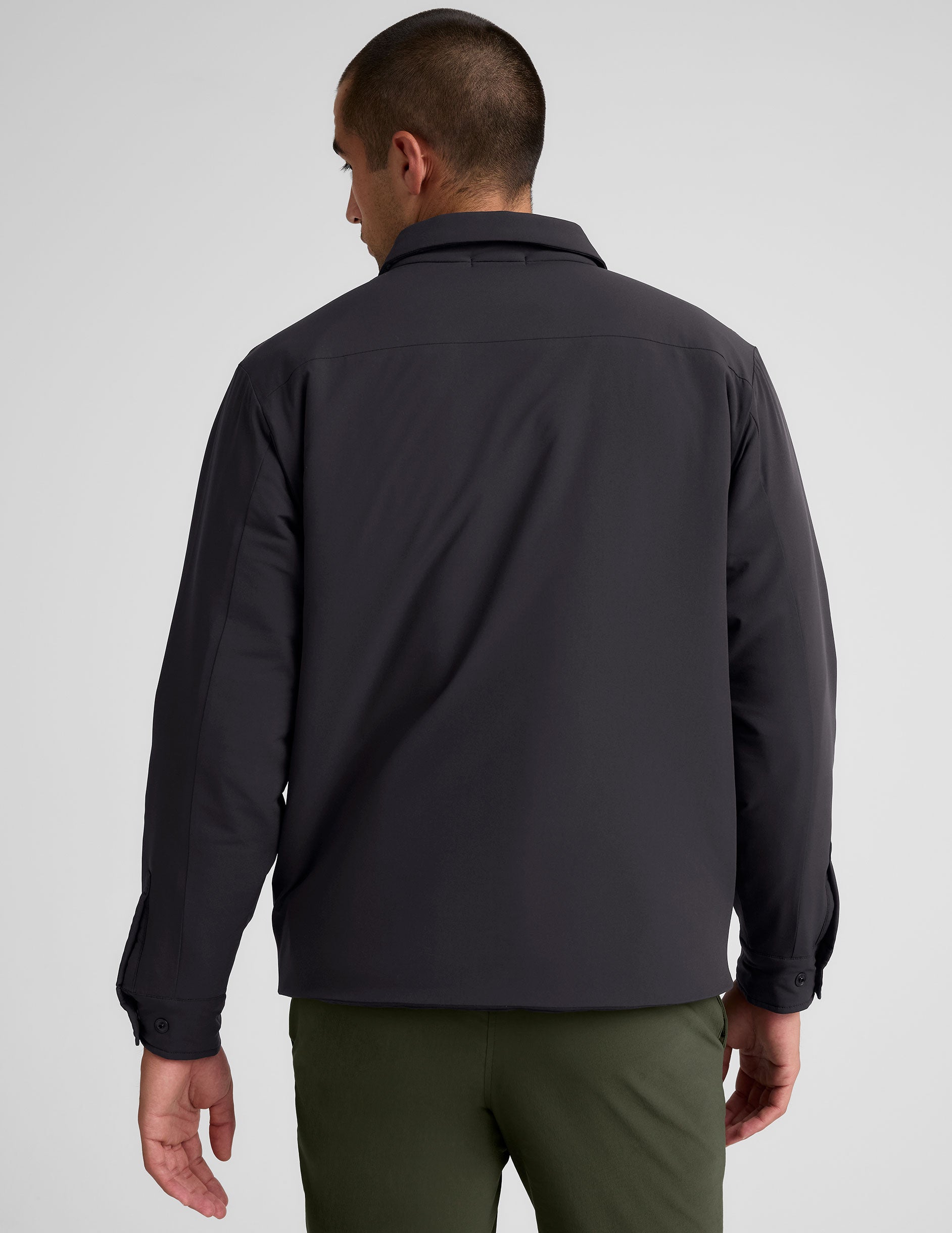 black men's button up insulated jacket with a shirt collar and side seam invisible zipper pockets.