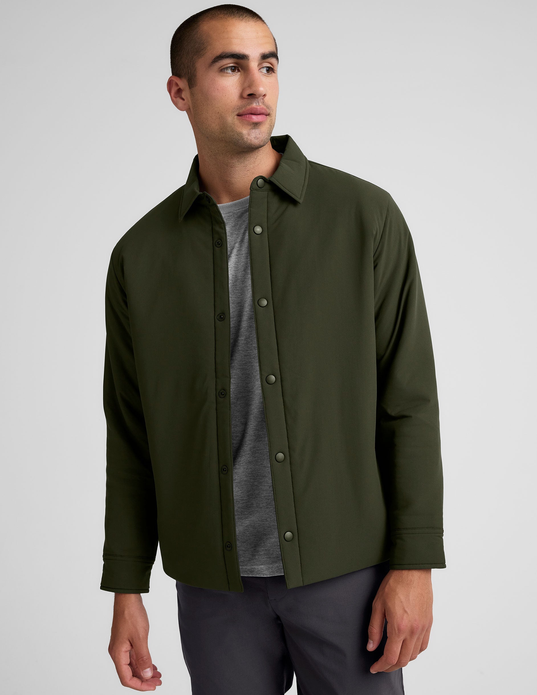 green men's button up insulated jacket with a shirt collar and side seam invisible zipper pockets.