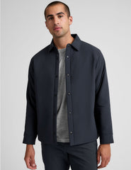 blue men's button up insulated jacket with a shirt collar and side seam invisible zipper pockets.