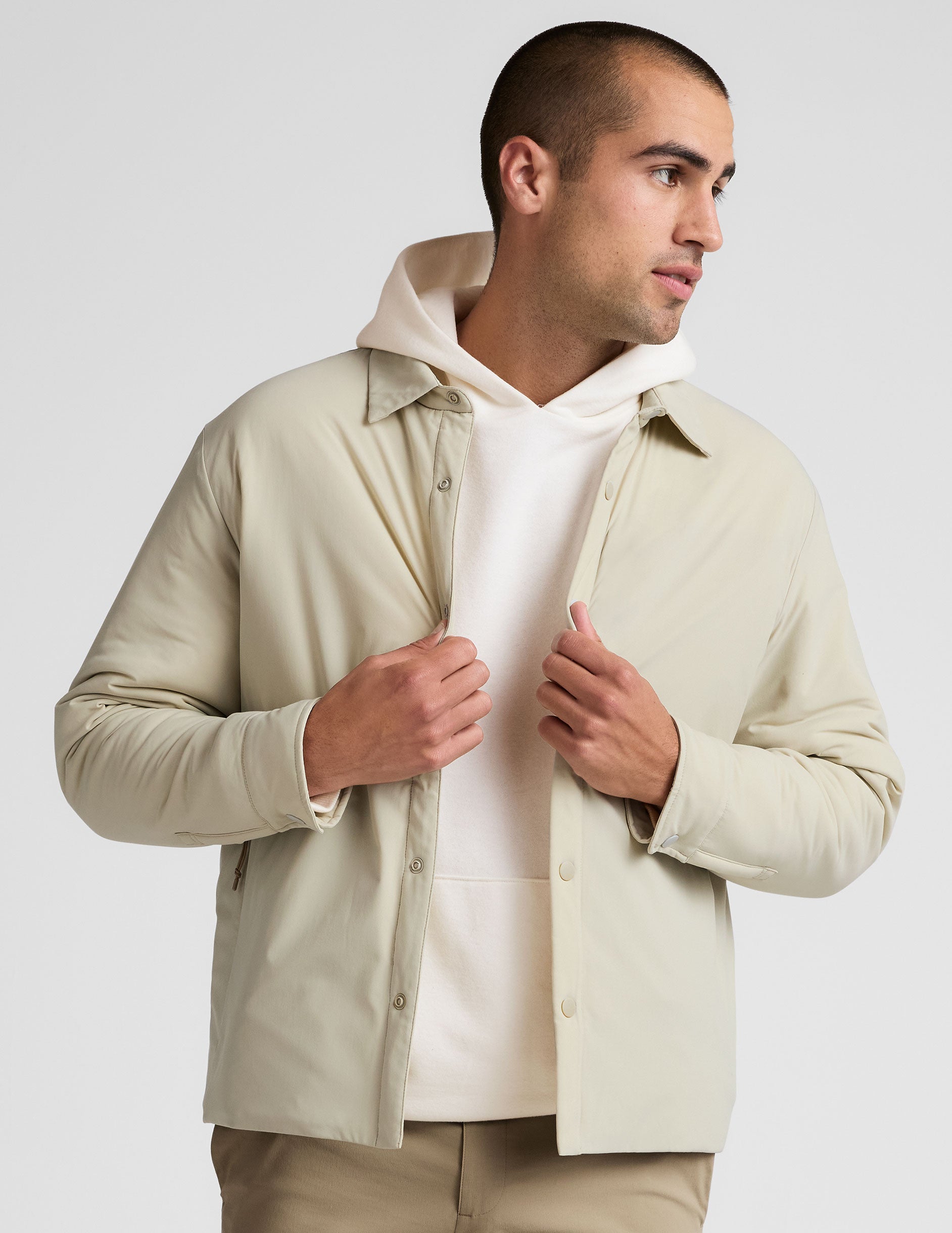 brown men's button up insulated jacket with a shirt collar and side seam invisible zipper pockets.