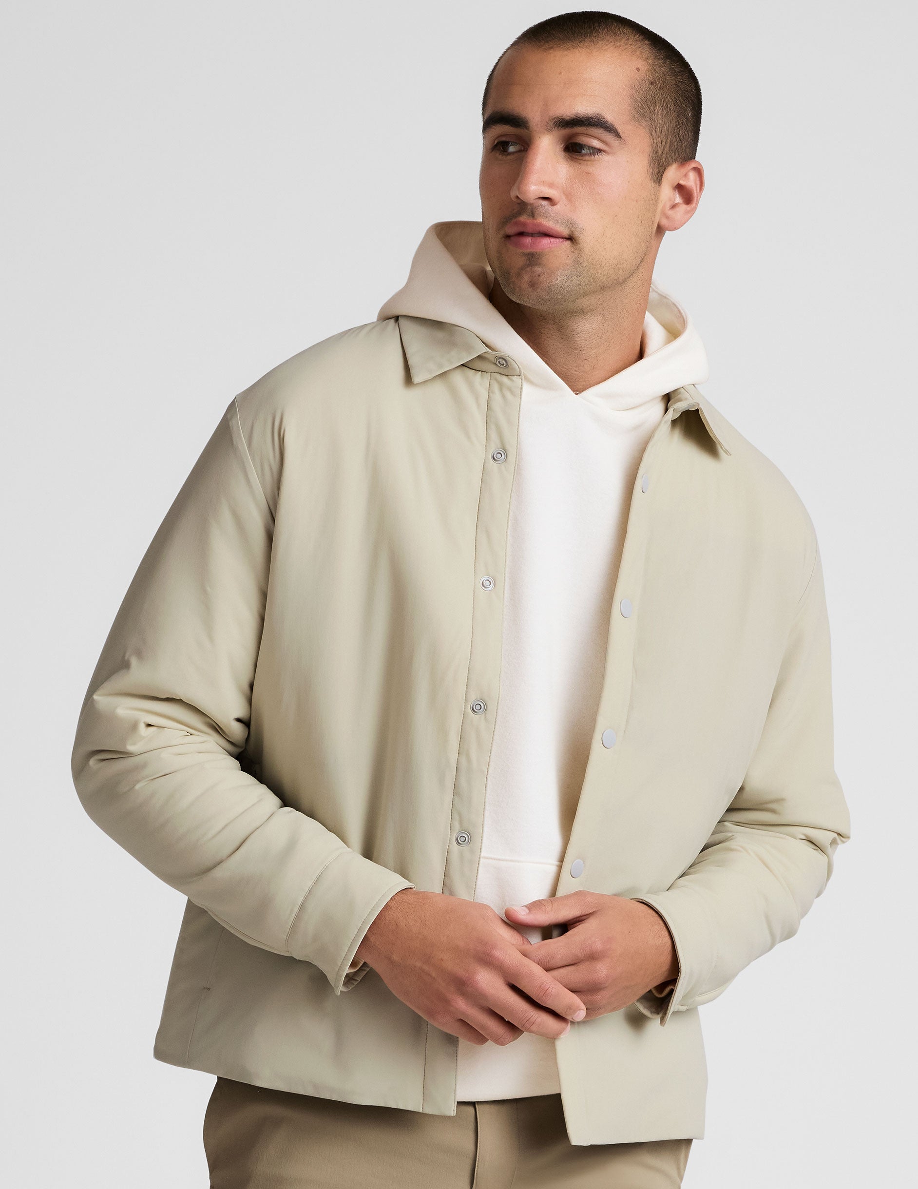 brown men's button up insulated jacket with a shirt collar and side seam invisible zipper pockets.
