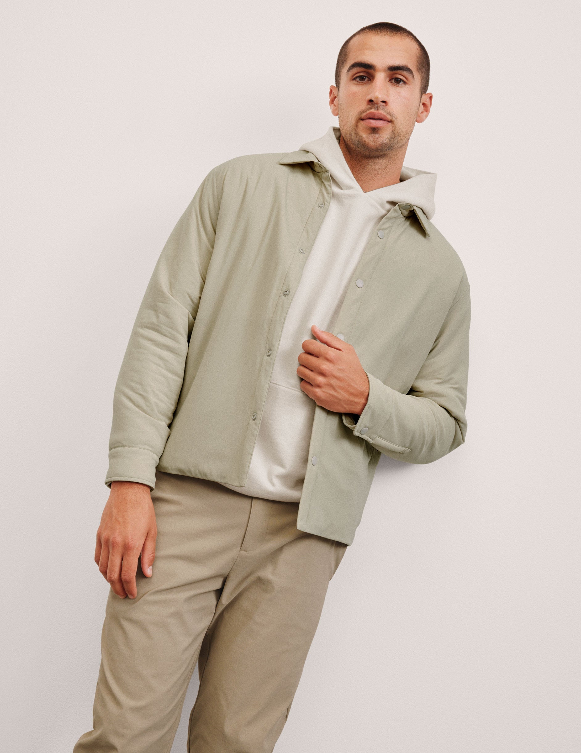 brown men's button up insulated jacket with a shirt collar and side seam invisible zipper pockets.