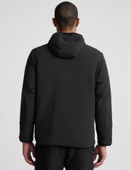 male model wearing a black zip-up jacket with a hood and pockets against a plain background.