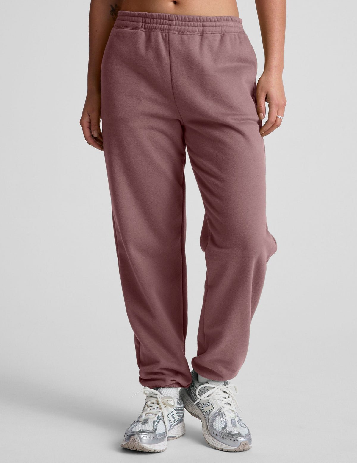 pink sweatpants with pockets and a drawstring at waistband.