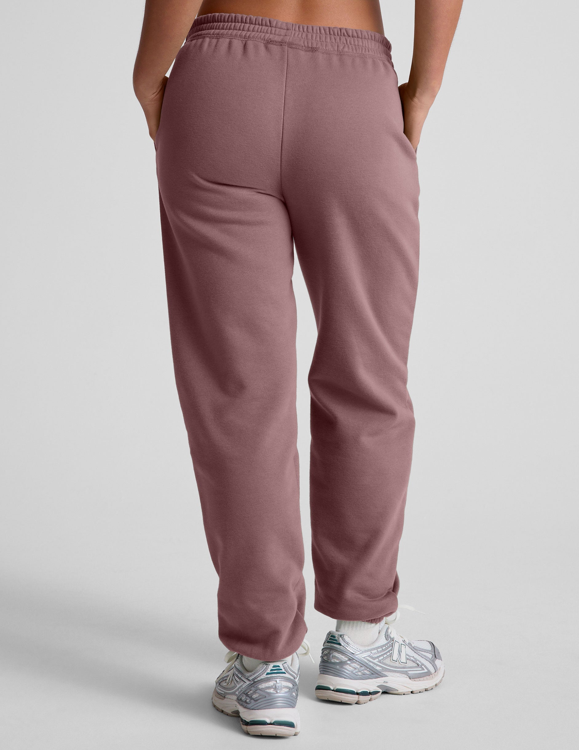 pink sweatpants with pockets and a drawstring at waistband.
