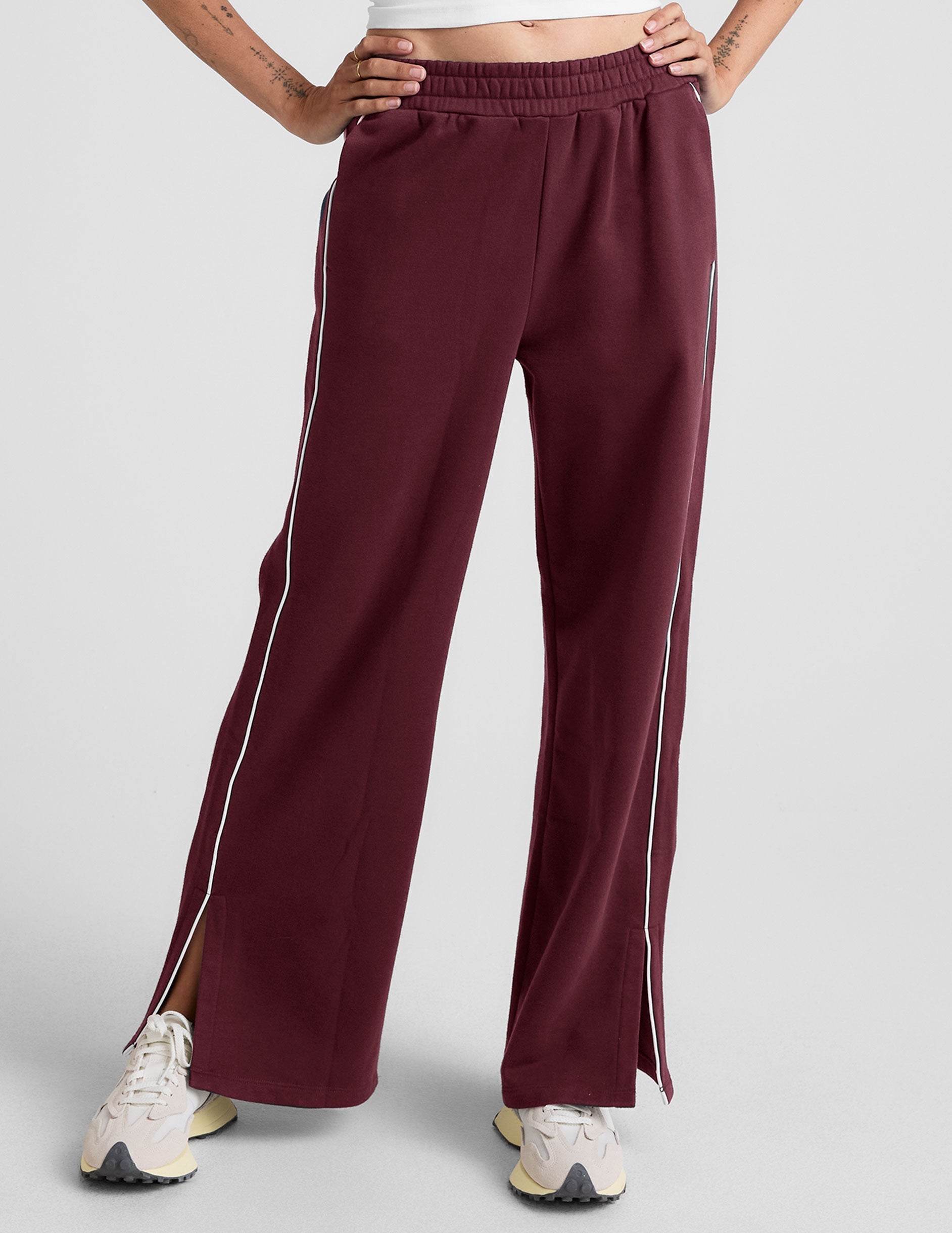 red sweatpant with a mid rise elasticated waistband and contrast piping trim down sides of leg.