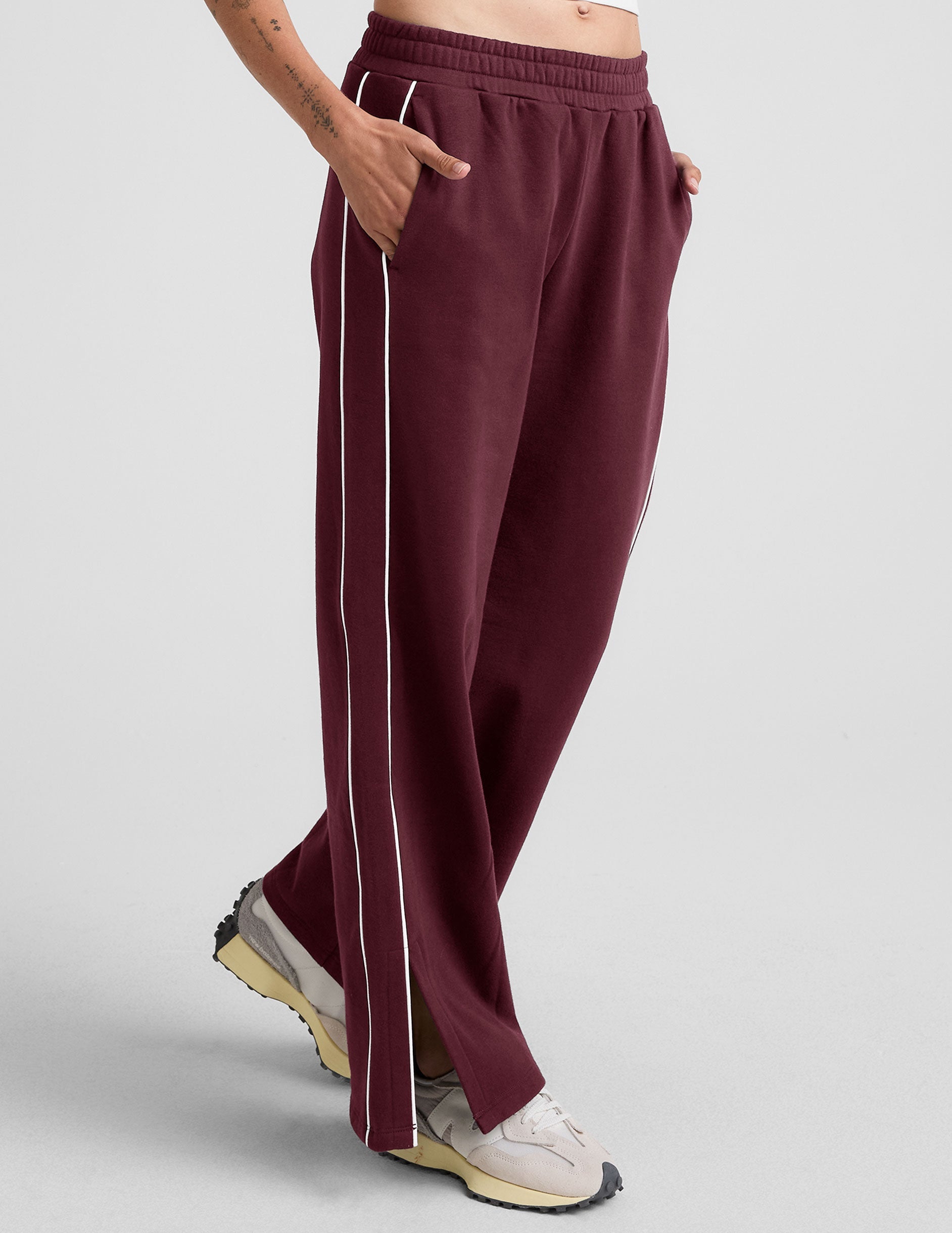 red sweatpant with a mid rise elasticated waistband and contrast piping trim down sides of leg.