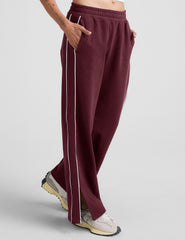 red sweatpant with a mid rise elasticated waistband and contrast piping trim down sides of leg.