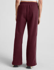 red sweatpant with a mid rise elasticated waistband and contrast piping trim down sides of leg.