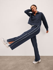 blue sweatpant with a mid rise elasticated waistband and contrast piping trim down sides of leg.