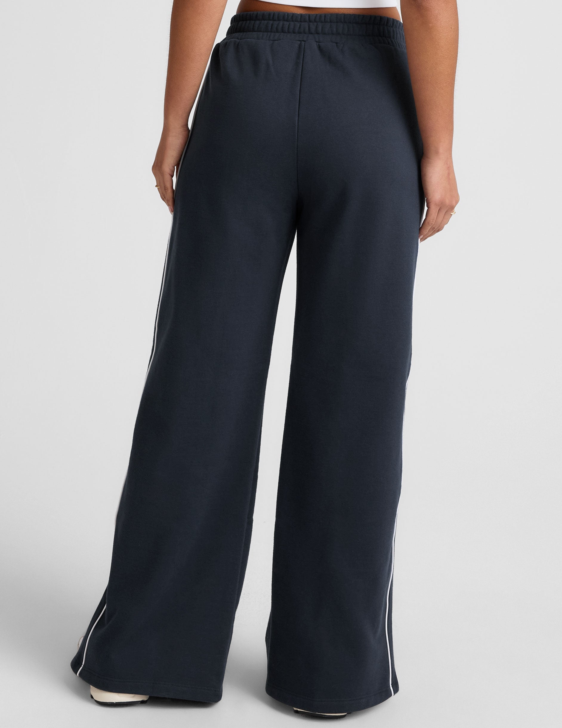 blue sweatpant with a mid rise elasticated waistband and contrast piping trim down sides of leg.