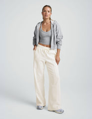 model wearing a grey tank and white fleece wide leg pants against a plain background.