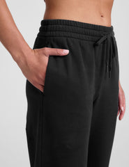 black mid-rise wide leg sweatpants with side slits and a drawcord at waistband.