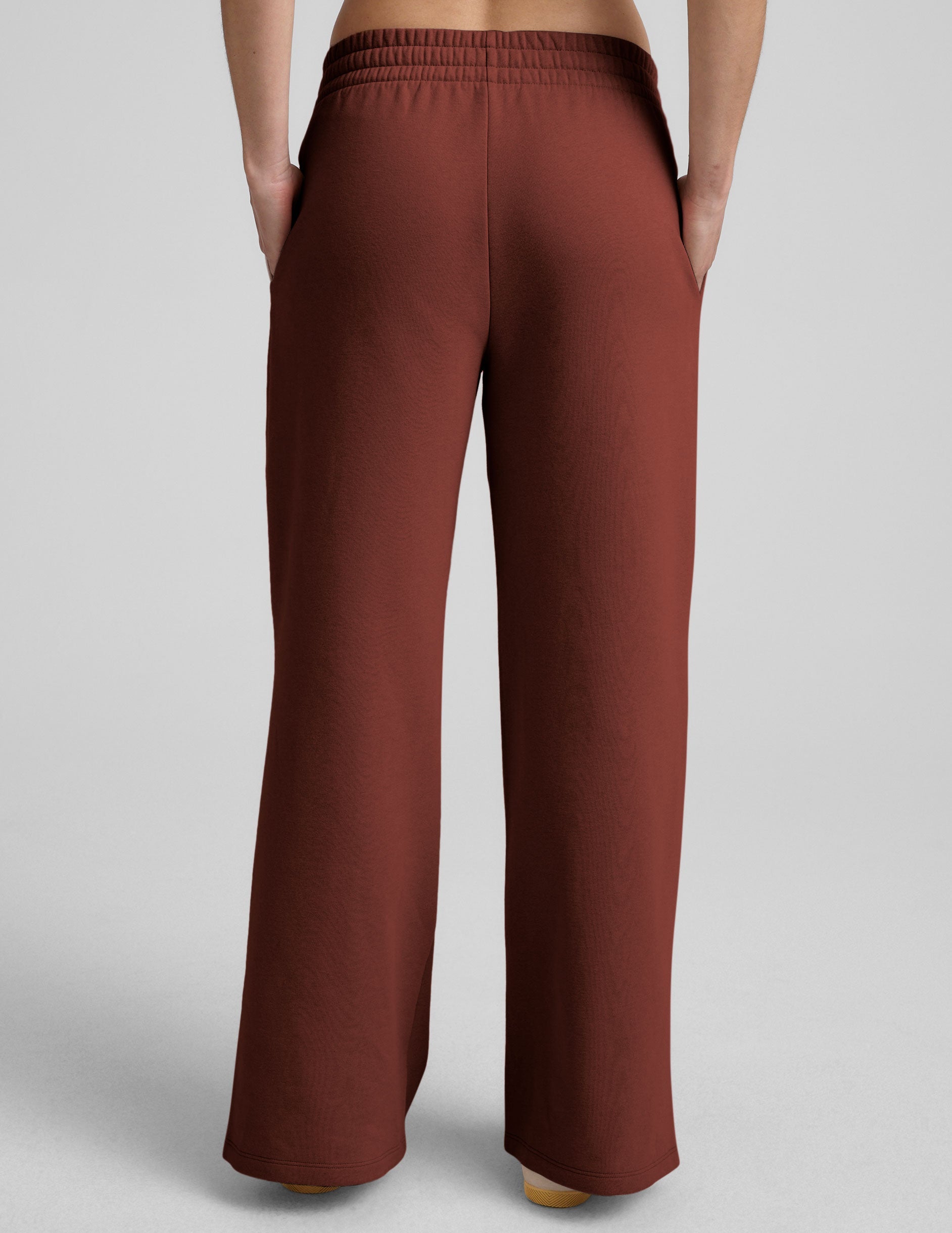 brown mid-rise wide leg sweatpants with side slits and a drawcord at waistband.