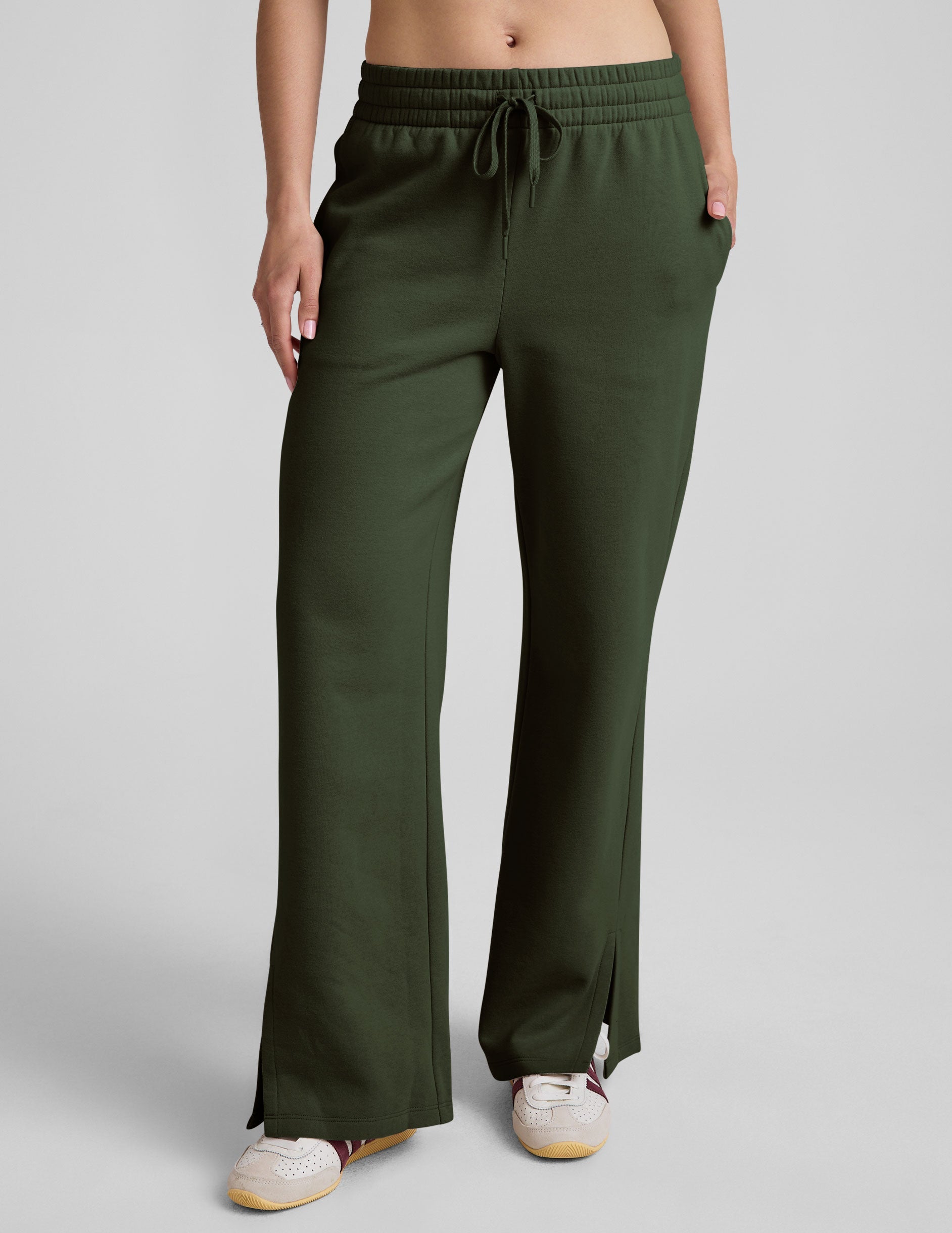 green mid-rise wide leg sweatpants with side slits and a drawcord at waistband.