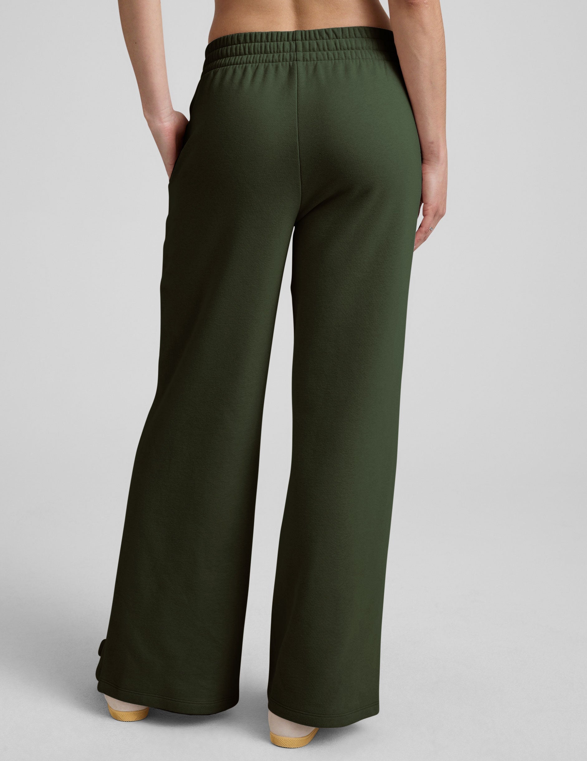 green mid-rise wide leg sweatpants with side slits and a drawcord at waistband.