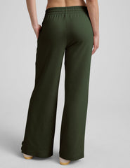 green mid-rise wide leg sweatpants with side slits and a drawcord at waistband.