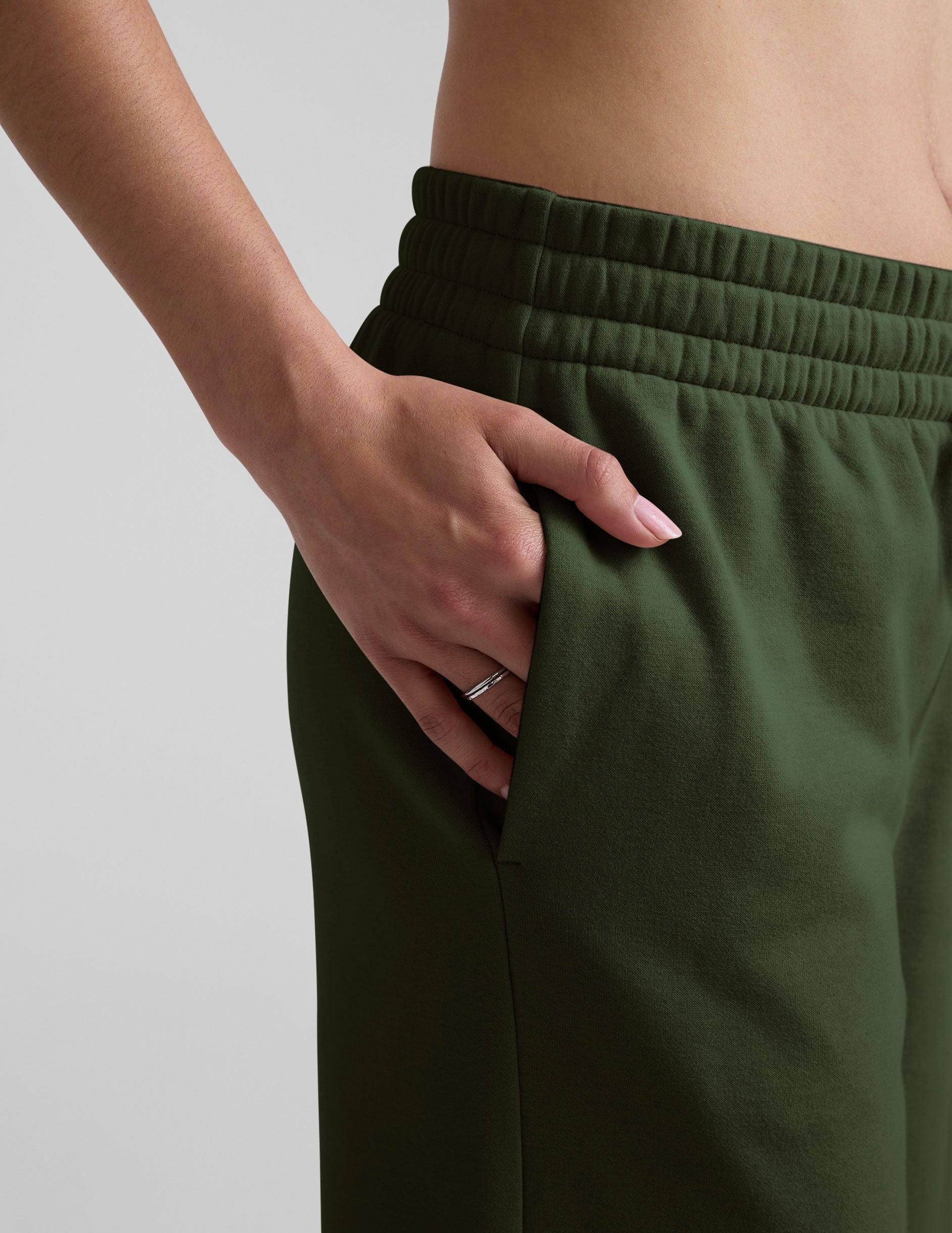 green mid-rise wide leg sweatpants with side slits and a drawcord at waistband.