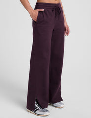 purple fleece wide leg pants with slits on side and a drawcord at waistband on a white background.