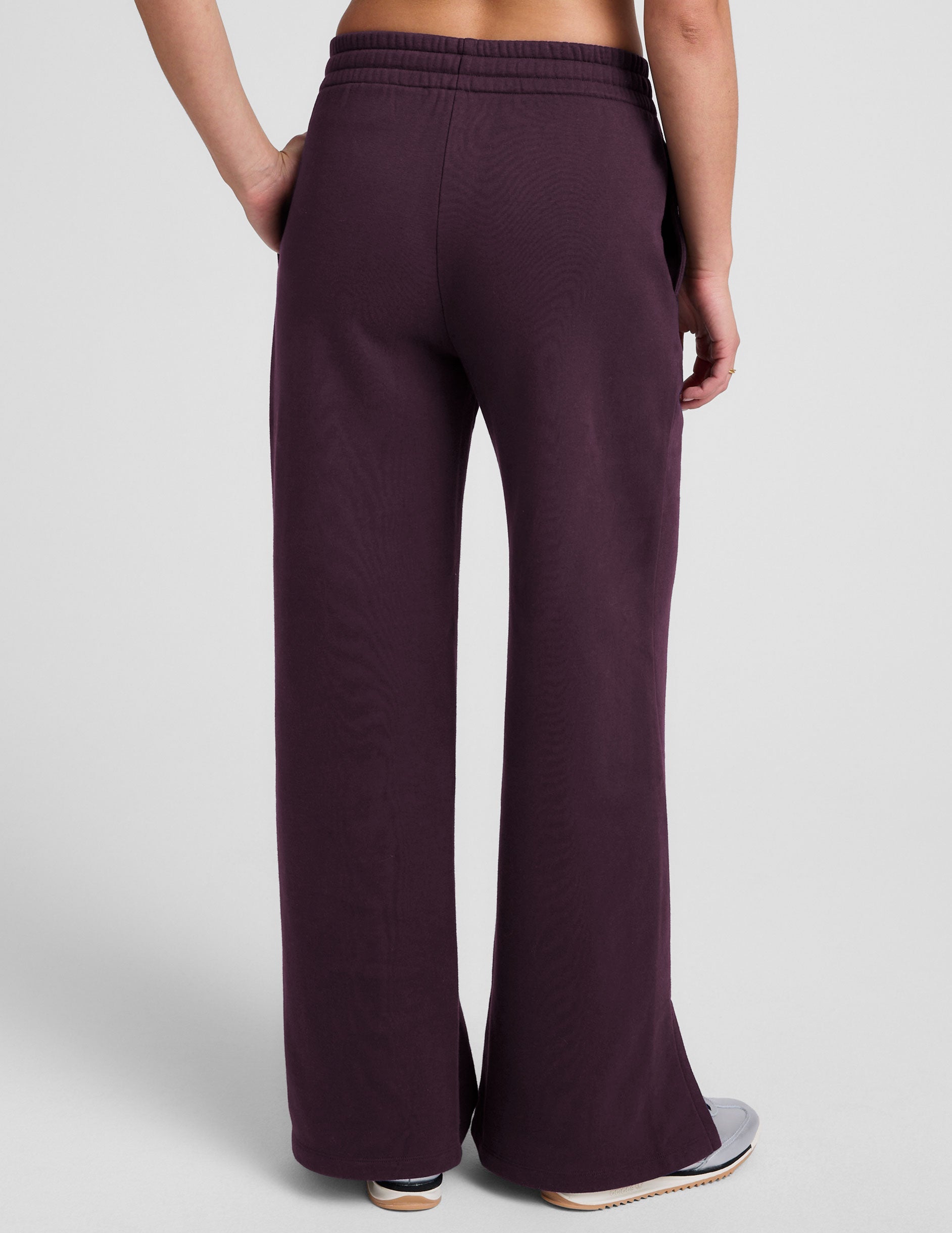 purple fleece wide leg pants with slits on side and a drawcord at waistband on a white background.