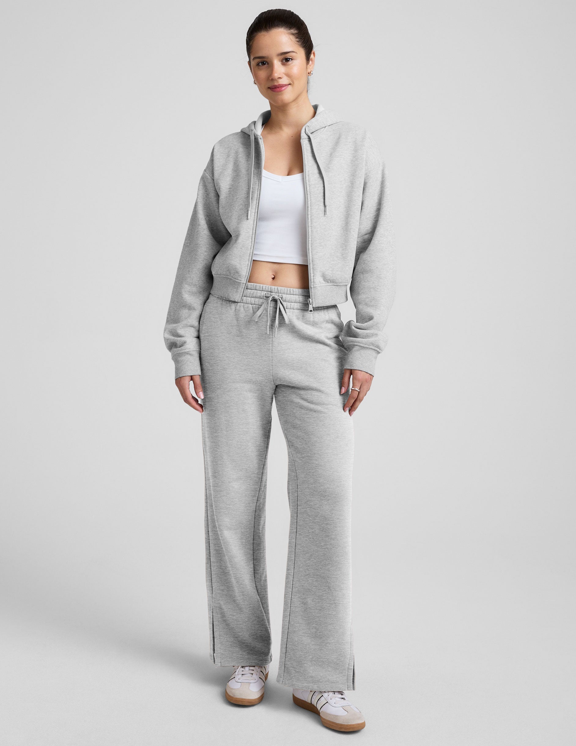 grey mid-rise wide leg sweatpants with side slits and a drawcord at waistband.
