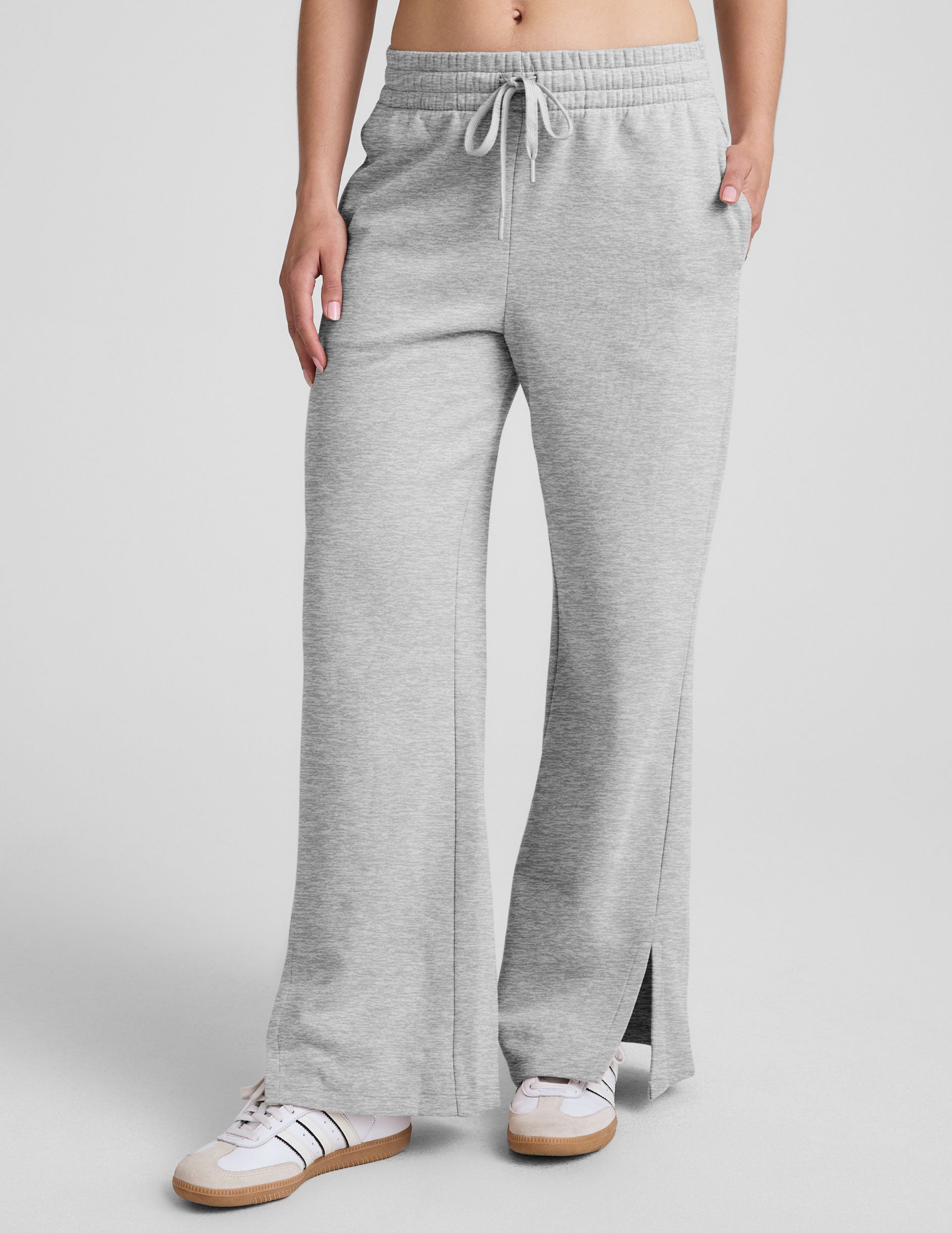grey mid-rise wide leg sweatpants with side slits and a drawcord at waistband.