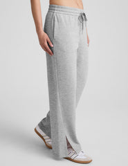 grey mid-rise wide leg sweatpants with side slits and a drawcord at waistband.